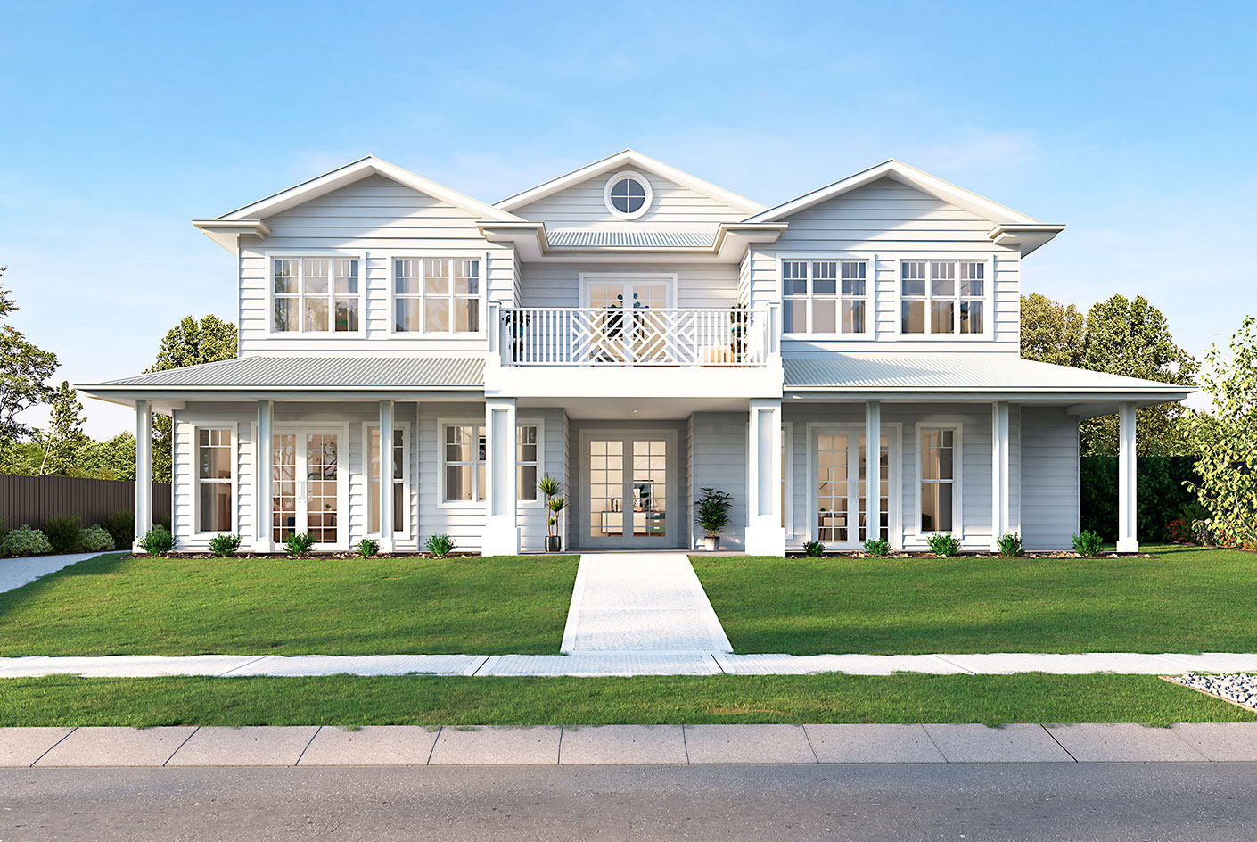 A large, light blue Hamptons-style home with a spacious front lawn, featuring large windows, a balcony, and symmetrical design.