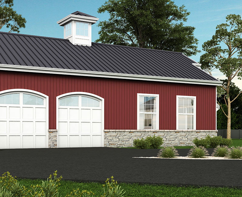 Red industrial-style home with a metal roof, featuring large white garage doors and stone detailing at the base, surrounded by greenery.